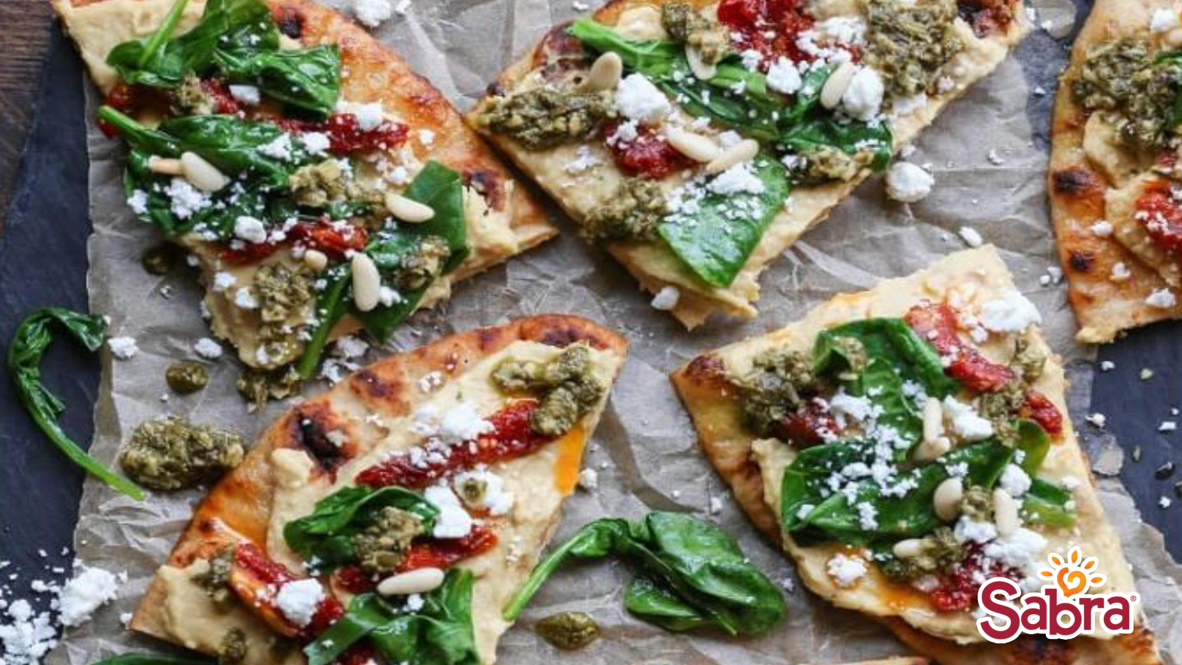 Image for Recipe Hummus Flatbread with SunDried Tomatoes, Spinach and Pesto